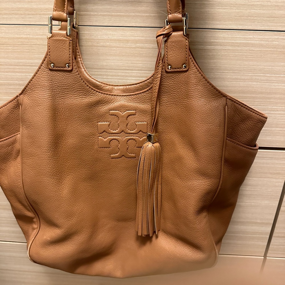 Authentic Tory Burch large camel colored tote with tassel. Good condition.